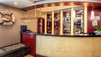 A reception area with a curved counter, a life preserver sign, and a variety of items on shelves behind the counter.