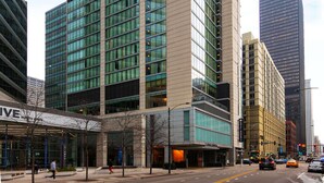 A modern high-rise building with a glass facade, surrounded by other tall buildings. - The Royal Sonesta Chicago River North (Chicago)