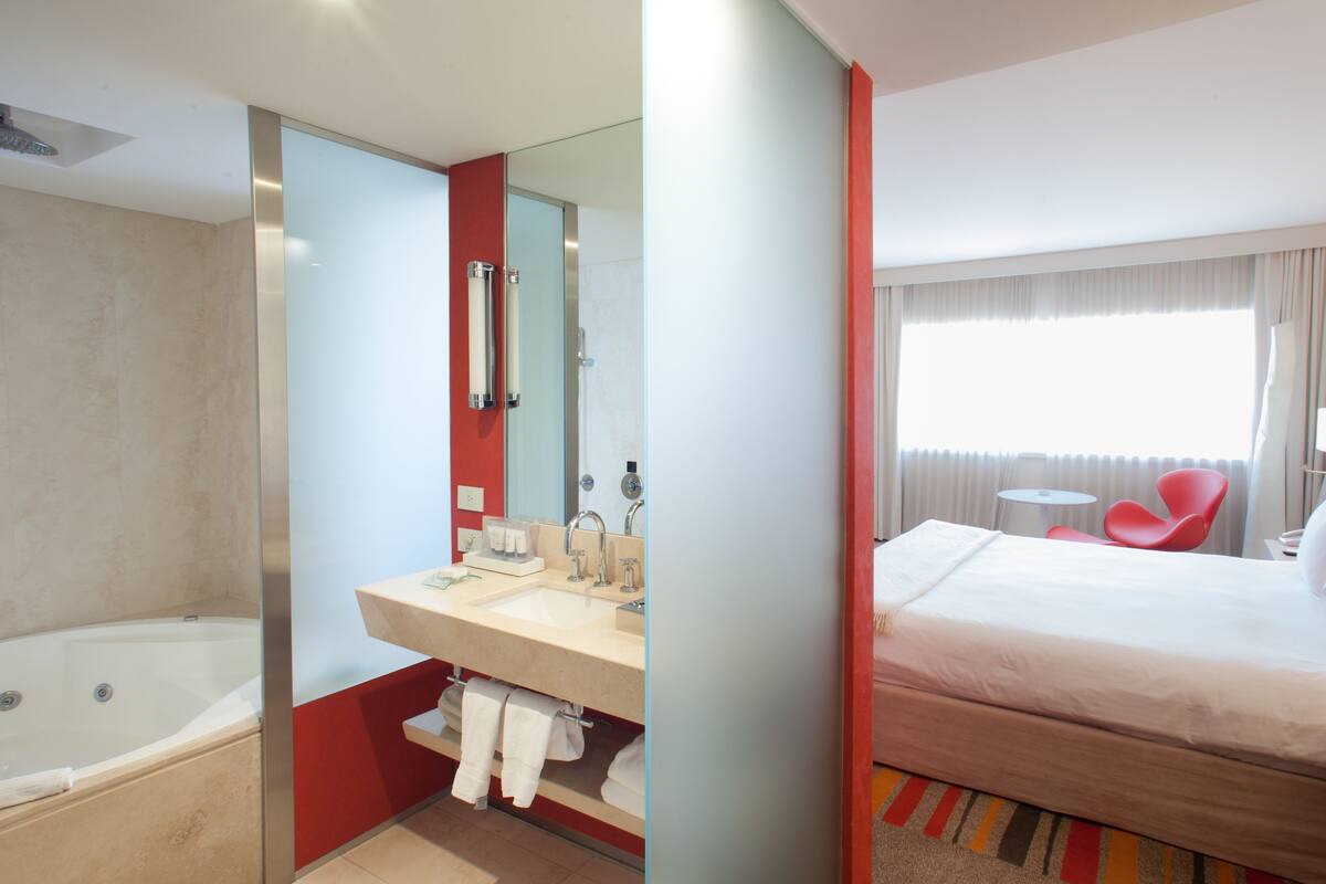 superior double room | bathroom | bathtub, rainfall showerhead, free toiletries, hair dryer