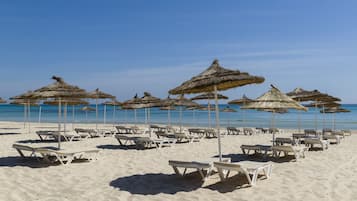 Plage privée, sable blanc, chaises longues, parasols