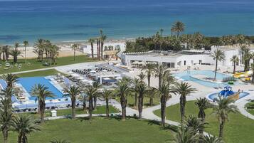 Relax by the pool surrounded by lush palm trees and ocean views.