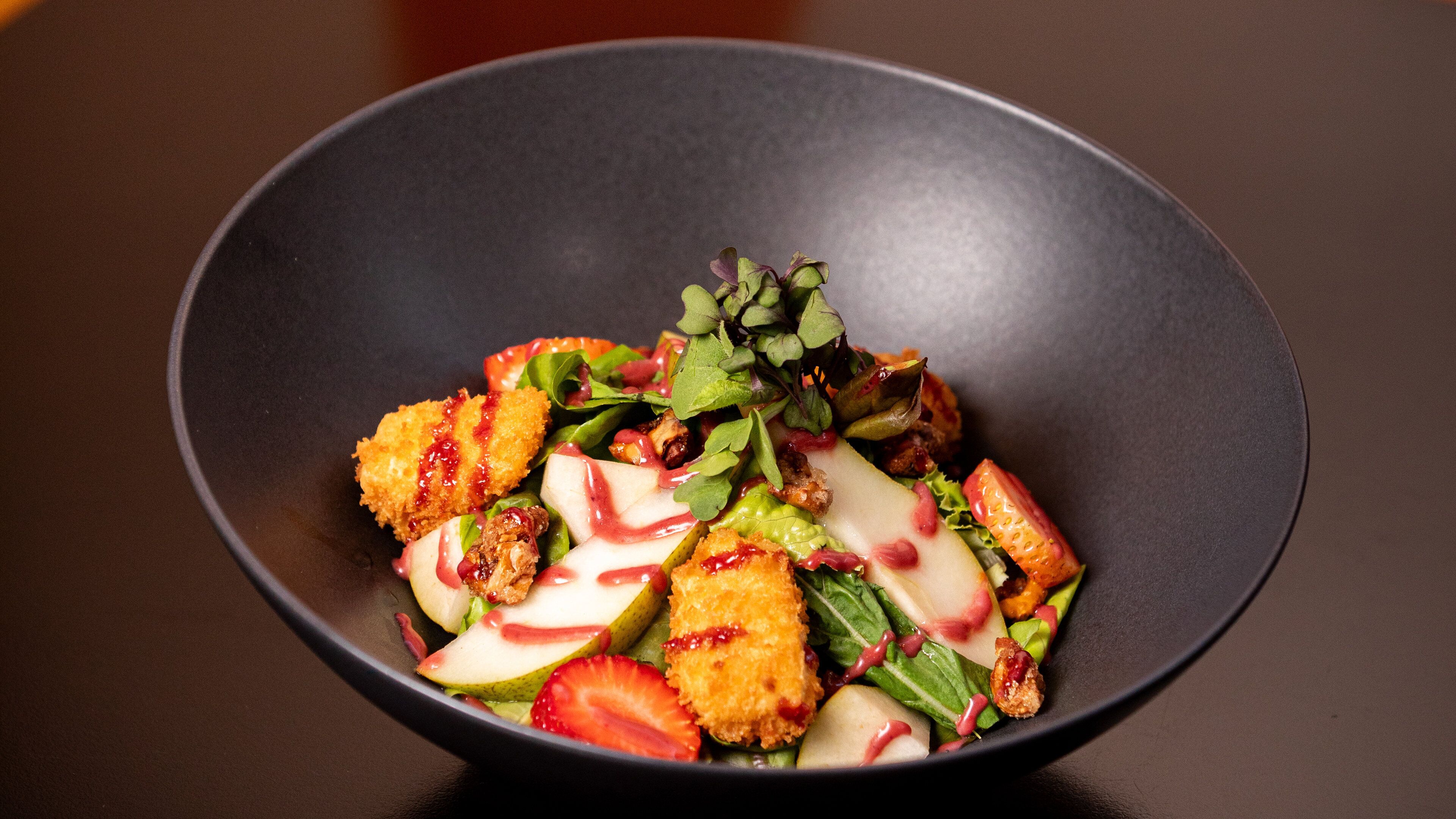 A bowl of salad with various ingredients.