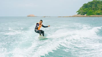 A person surfing on a wave in the ocean.