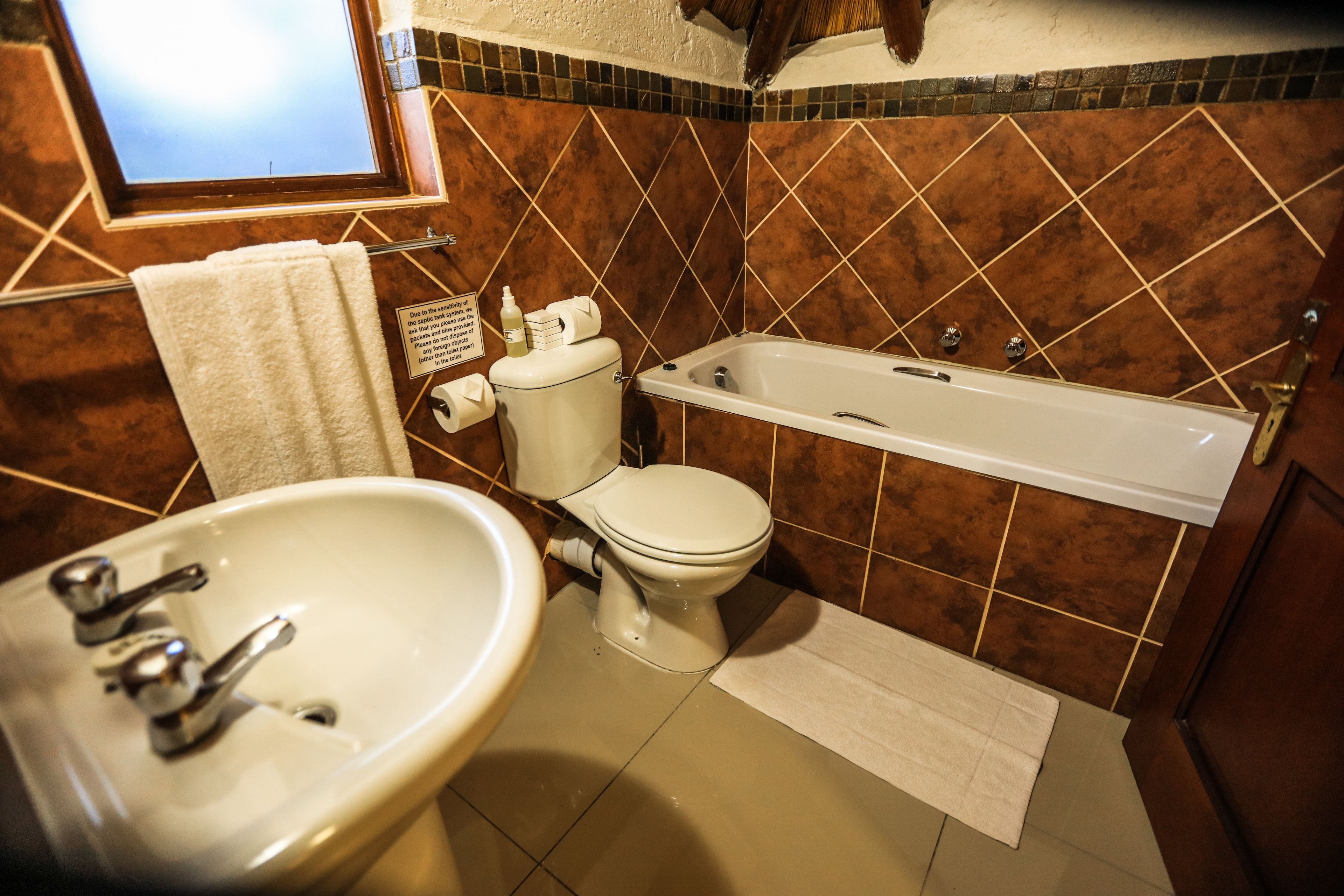 A bathroom with a sink, toilet, and bathtub.