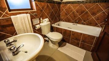 A bathroom with a sink, toilet, and bathtub.
