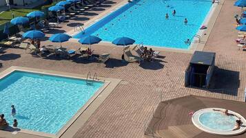 Seasonal outdoor pool, open 10:00 AM to 8:00 PM, pool umbrellas