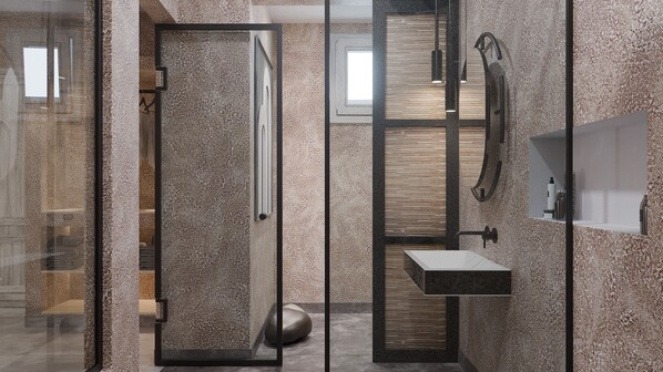 A modern bathroom with a glass shower enclosure, a wooden vanity, and a built-in sink.