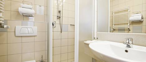 A bathroom with a toilet, a sink, a shower, and a towel rack.