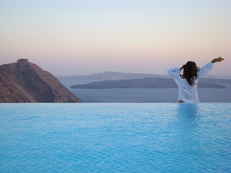 Outdoor pool, pool umbrellas, pool loungers. Aenaon Villas