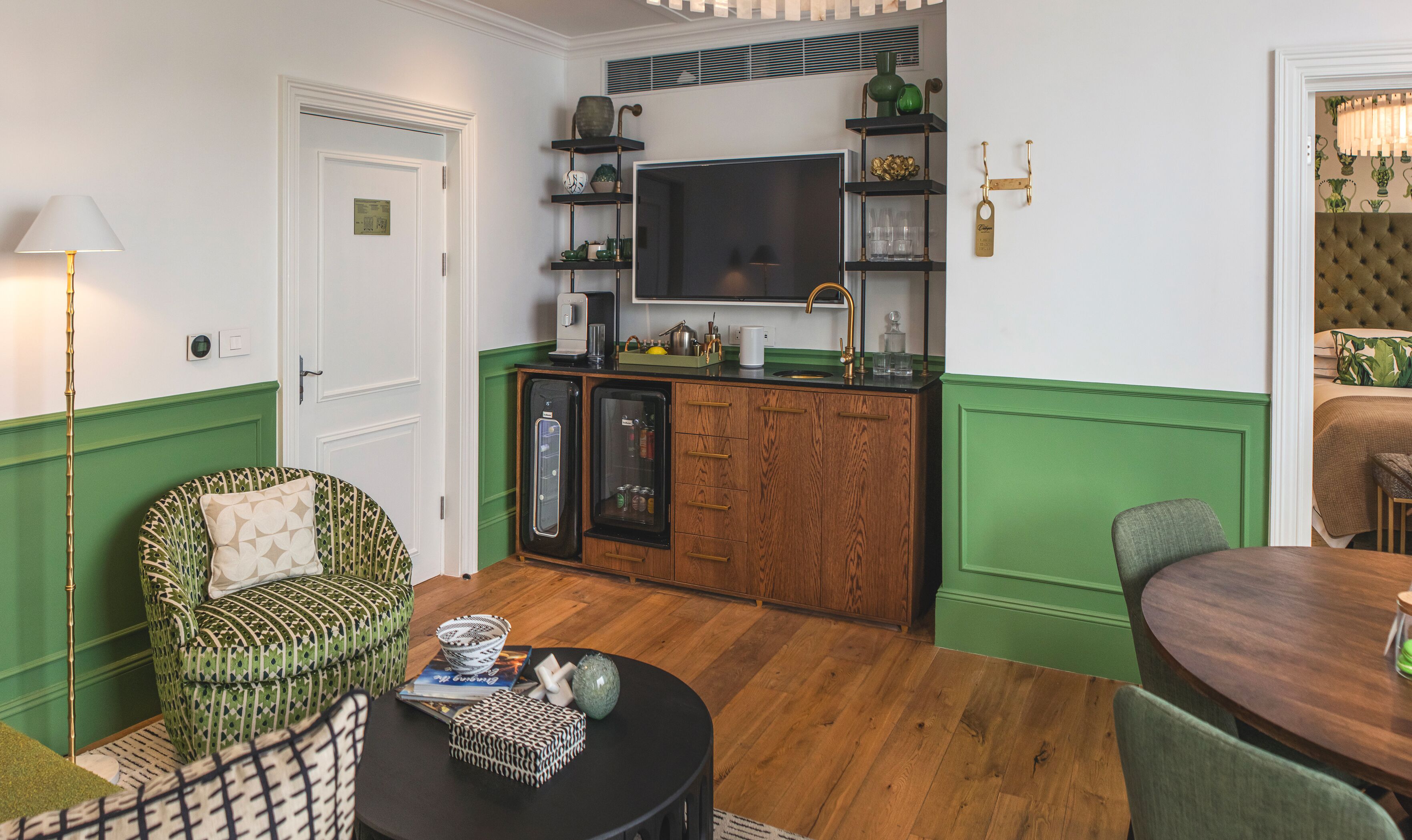 A compact living space with a kitchenette, a dining area, and a seating area with patterned furniture.