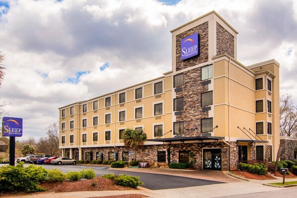 A Sleep Inn & Suites hotel with a stone facade, multiple balconies, and a parking lot. - Sleep Inn & Suites Athens South (Athens)
