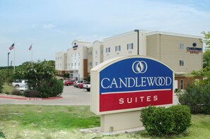 A hotel sign with 'CANDLEWOOD SUITES' prominently displayed.