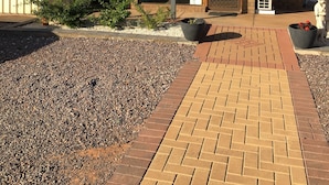 A building with a reception area, a tiled roof, and a small garden with gravel and plants. - Airport Whyalla Motel (Whyalla Norrie)