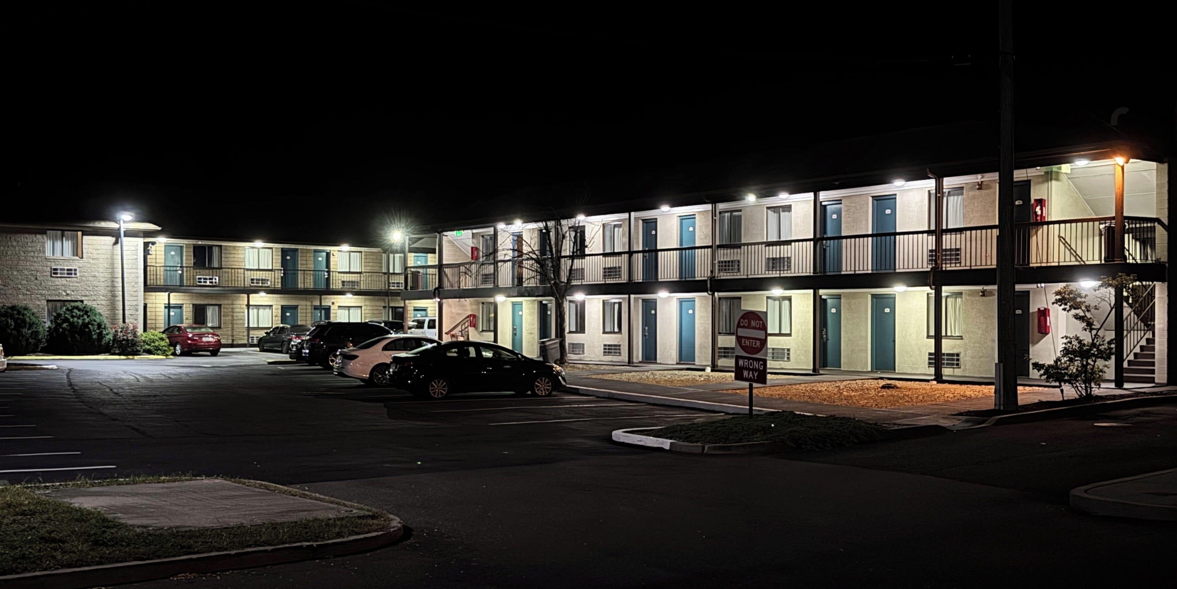 A motel with multiple rooms, a parking lot, and a 'Do Not Enter' sign.