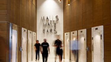 A modern interior with a marble wall and elevators.