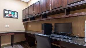 A modern office space with a dark wood desk, a black office chair, a desktop computer, and a flat-screen monitor. - Best Western Plus South Edmonton Inn & Suites (Edmonton)