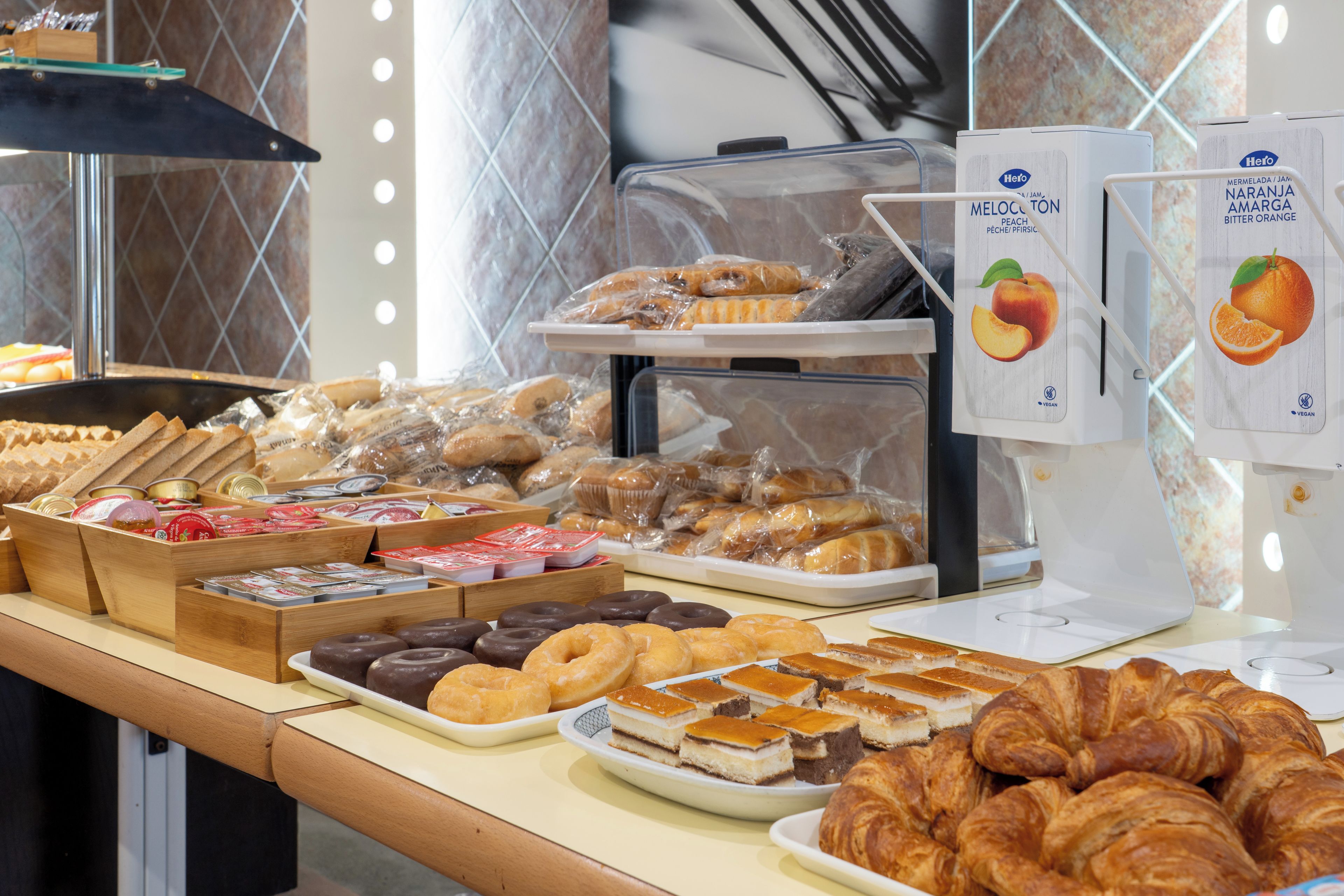 A bakery display with various baked goods including pastries, croissants, and chocolate items.