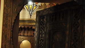 An ornate wooden door with intricate carvings and a mirror. - Riad Le Coq Berbere (Marrakech)