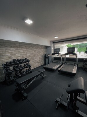 A gym with treadmills, dumbbells, and exercise equipment. - Ker Recoleta Hotel (Buenos Aires)