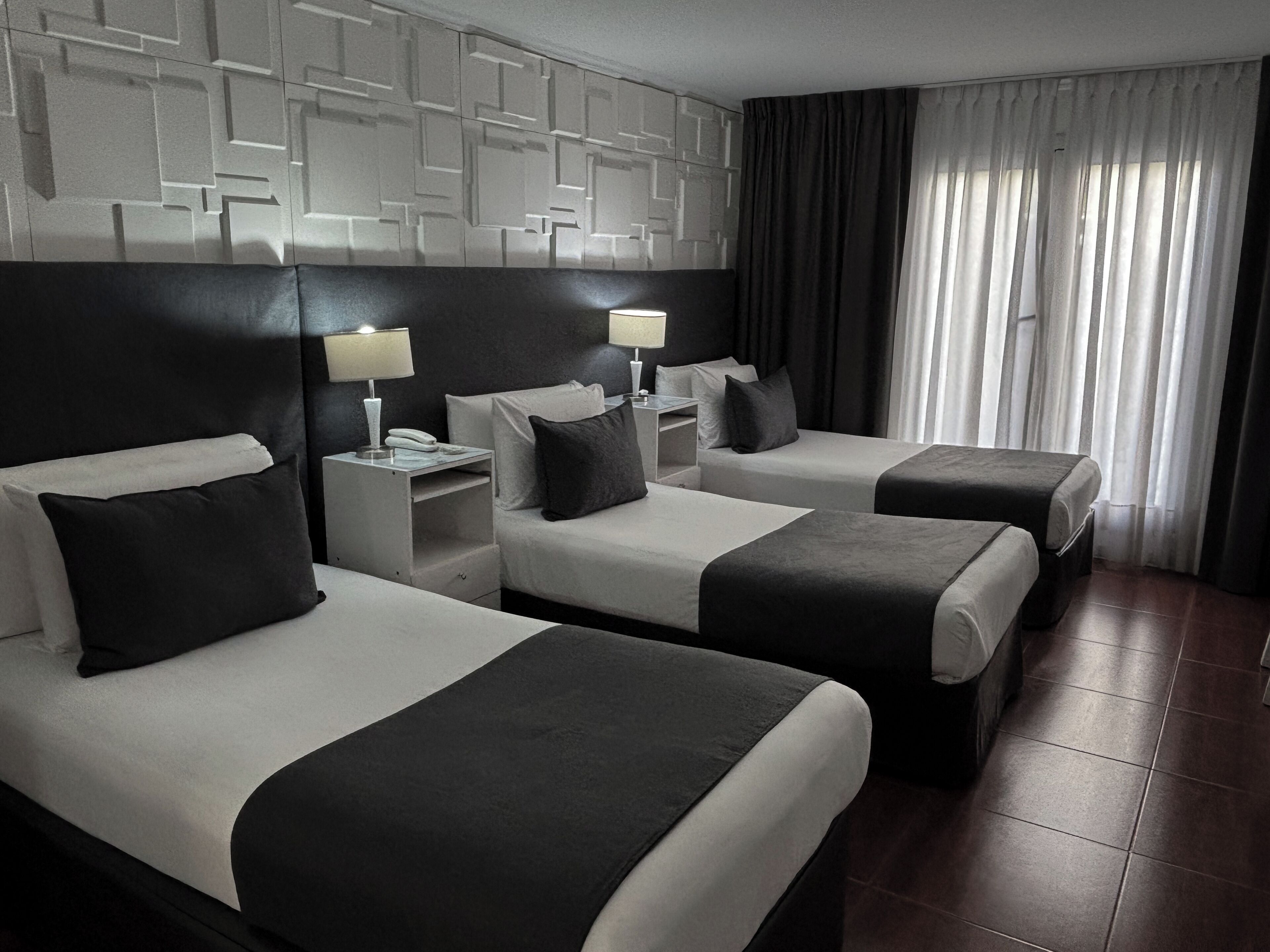 Executive Triple Room | Minibar, in-room safe, desk, soundproofing