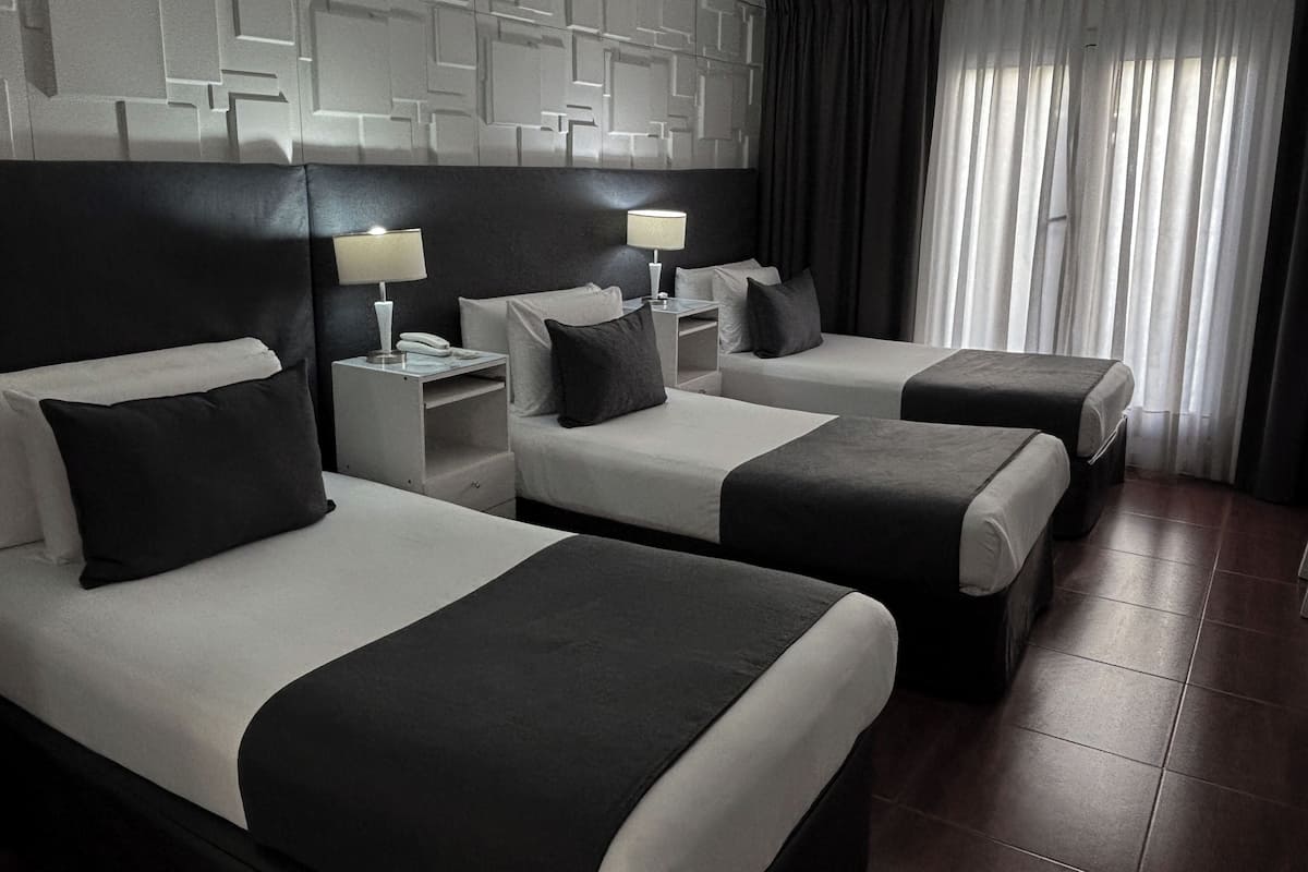 Executive Triple Room | Minibar, in-room safe, desk, soundproofing