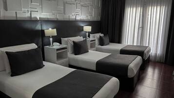Executive Triple Room | Minibar, in-room safe, desk, soundproofing