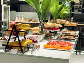 A buffet with various food items and a refrigerator in the background. - Ker Recoleta Hotel (Buenos Aires)