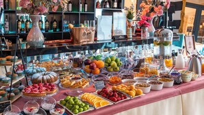 A buffet with a variety of food items including fruits, pastries, and desserts. - River Side Hotel (Tbilisi)