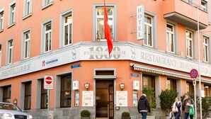 A hotel with a sign reading "RHEINFELDERHOF RESTAURANT RHEINFELDERHOF" and a red flag above the entrance. - Hotel Rheinfelderhof (Basel)