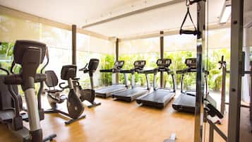 A gym with treadmills, elliptical machines, and weight equipment.