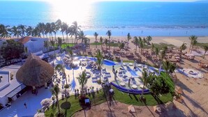 An aerial view of a resort with a central pool area, palm trees, and a beach in the background. - Marival Distinct All-Inclusive Handwritten Collection (Nuevo Nayarit)
