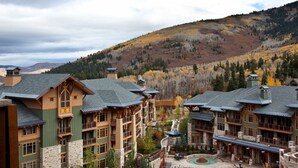 A resort with multiple buildings, a central pool area, and a mountainous backdrop. - Hyatt Centric Park City (Park City)