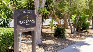 A sign for 'The Maraboon Tavern' indicating it is open 7 days a week.