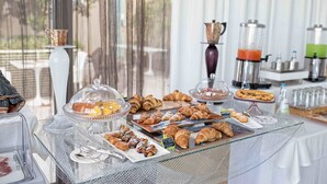 A buffet with various pastries and a coffee station. - Riviera Golf Resort (San Giovanni In Marignano)