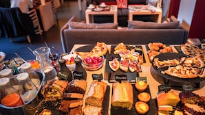 A buffet with various food items and a seating area in the background. - Hôtel Villa Koegui Biarritz (Biarritz)