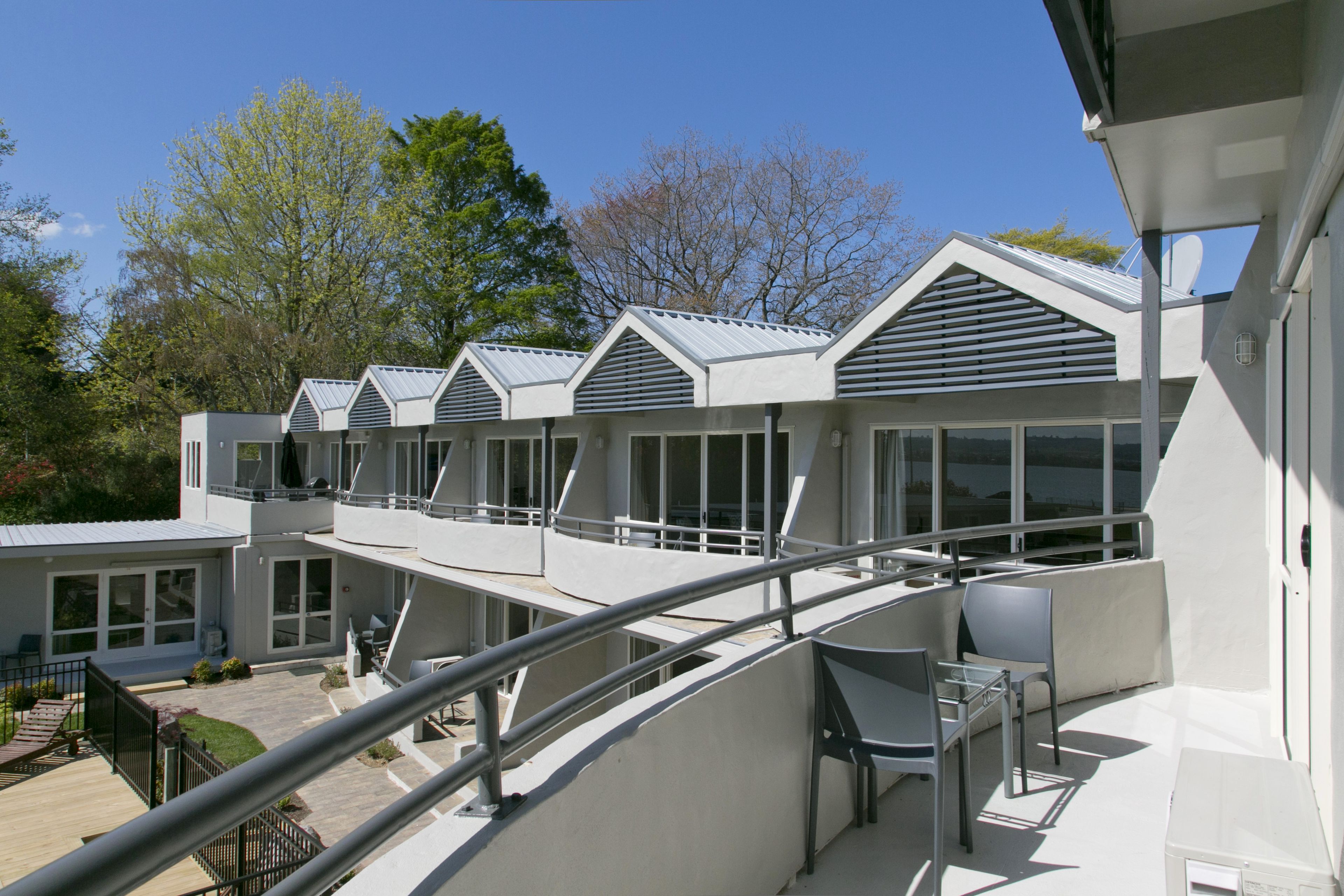 Et moderne hotel med flere altaner og store vinduer.
