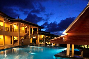 A hotel with a swimming pool, multiple balconies, and a covered area. - Baan Yuree Resort and Spa (Patong)