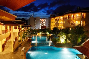 A hotel with a swimming pool, multiple balconies, and a staircase leading to the upper floors. - Baan Yuree Resort and Spa (Patong)
