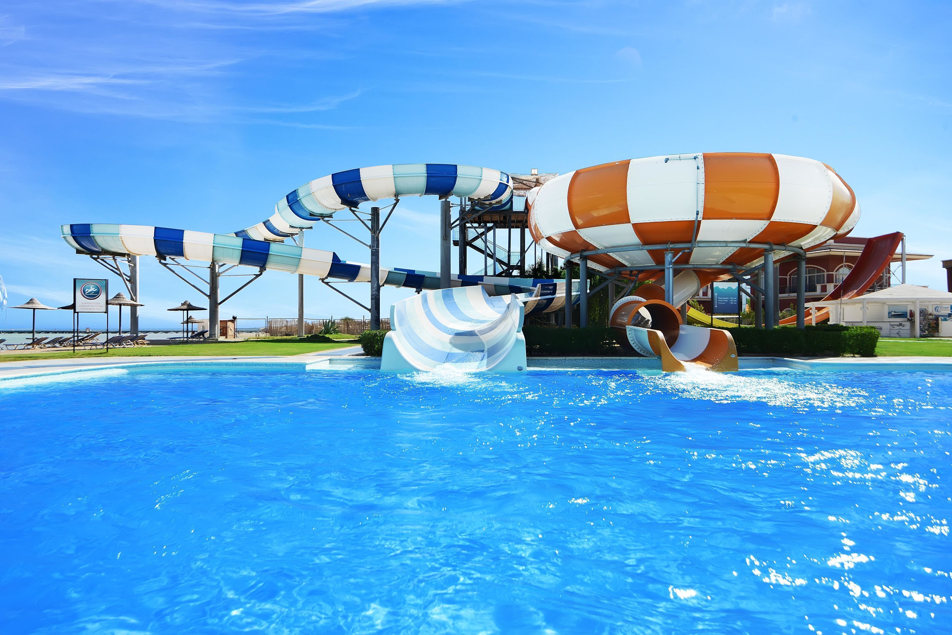 A water park with a pool, water slides, and a hot tub.