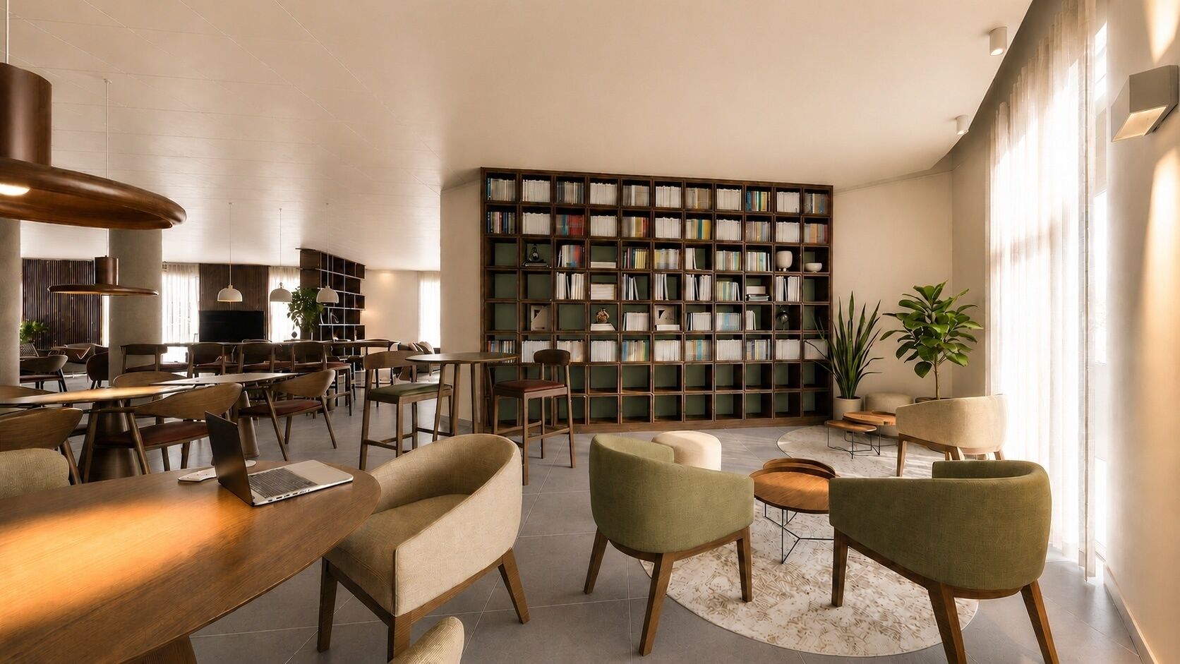 Una biblioteca moderna con estanterías, zonas de descanso y una gran televisión.