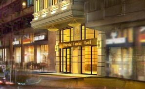 A hotel facade with a sign reading "Oriental Land Hotel." - Oriental Lander (Kowloon)