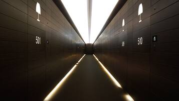 A modern, dimly lit hallway with numbers 501 and 510 indicating room locations.
