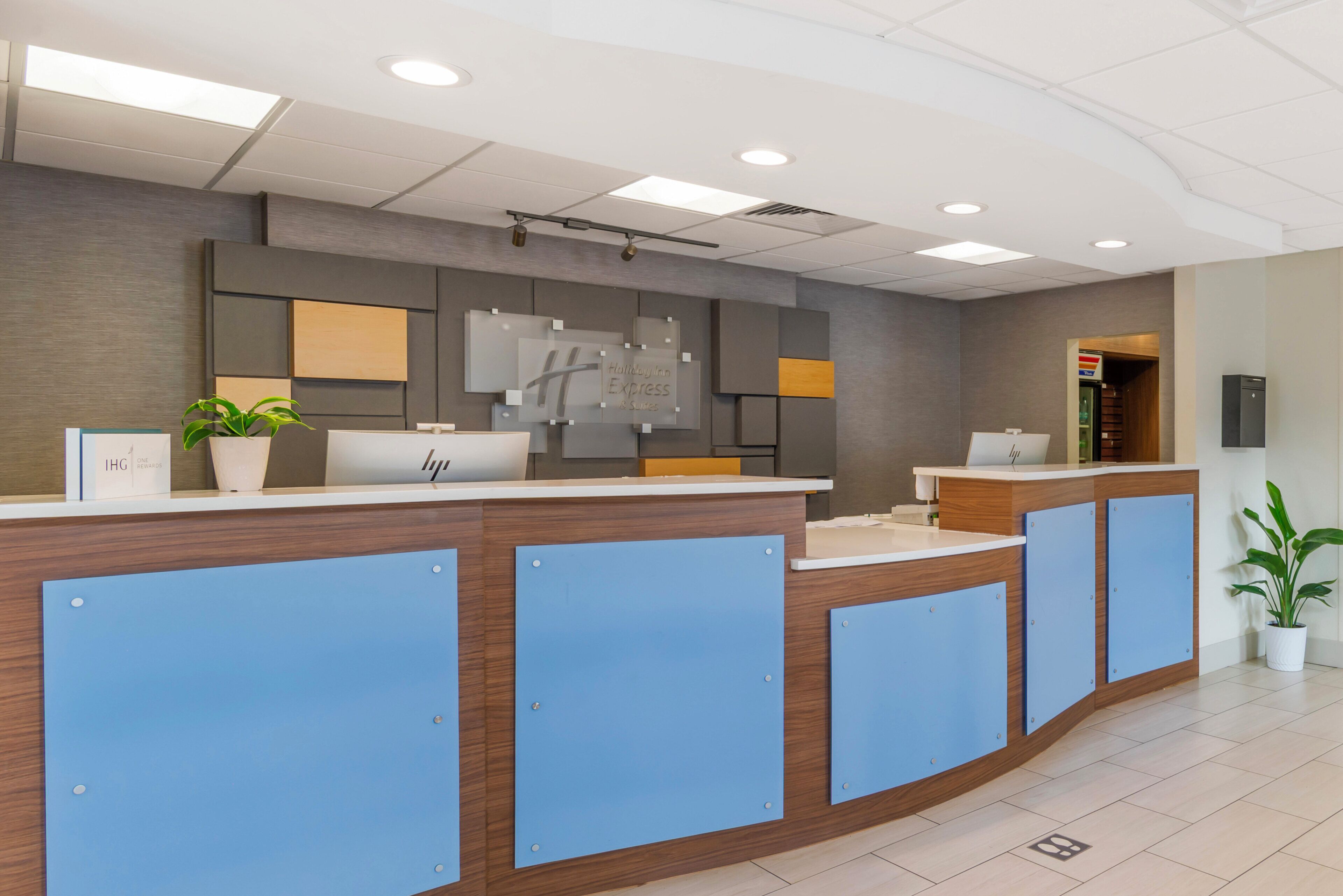 A reception desk with a modern design, featuring a wooden finish and blue accents.