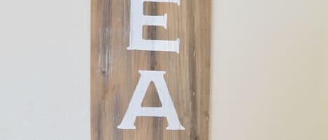 A wooden sign with the word "BEACH" and an arrow pointing to the right.