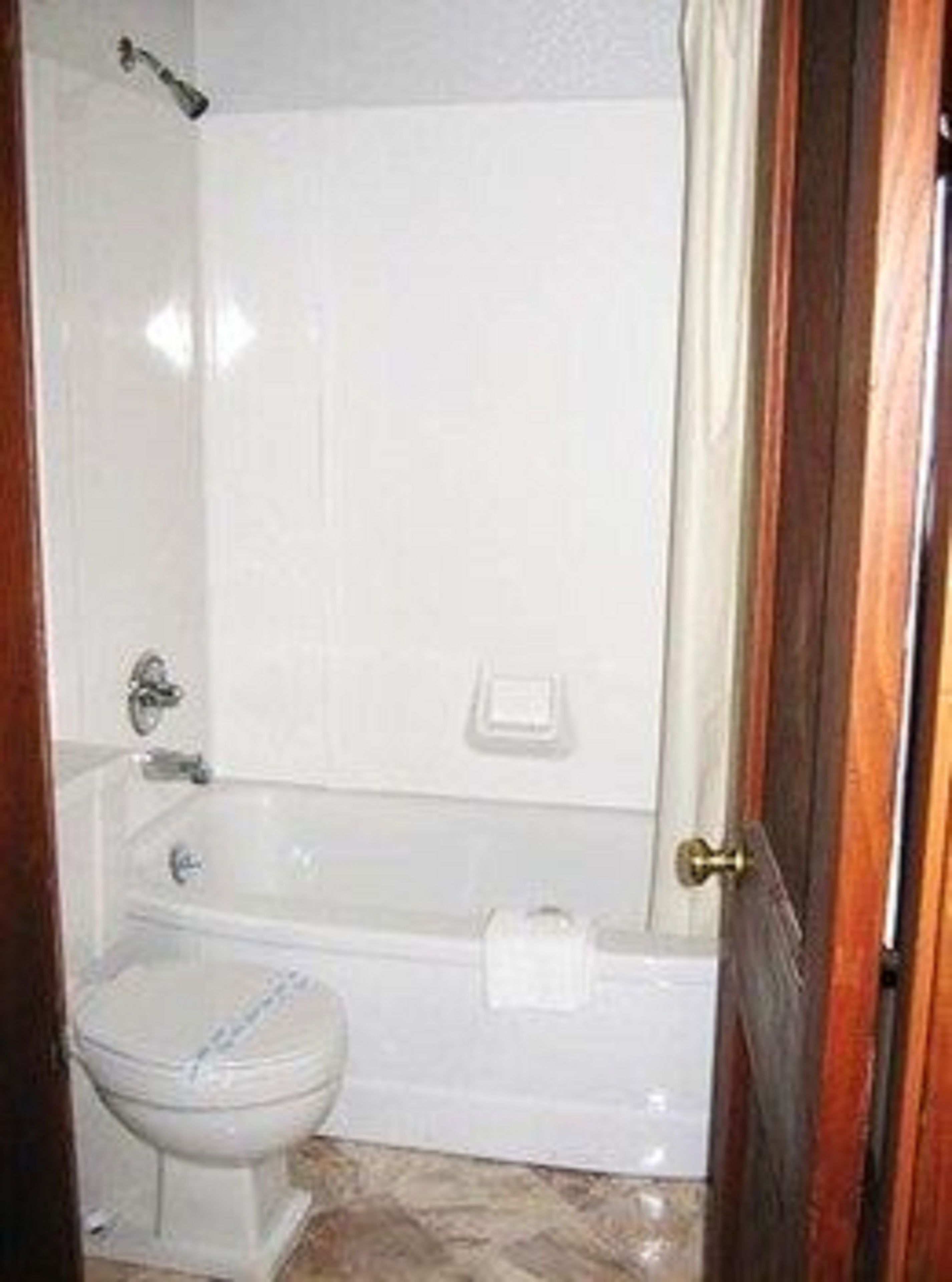Combined shower/bathtub, towels, toilet paper