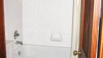 Combined shower/bathtub, towels, toilet paper