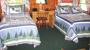 A room with two beds, a desk, and a chair. - Patio Motor Court (Twin Mountain)