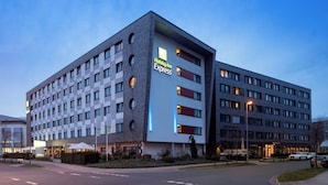 A Holiday Inn Express hotel with a modern design, featuring a checkered facade and multiple windows. - Holiday Inn Express Bremen Airport by IHG (Bremen)