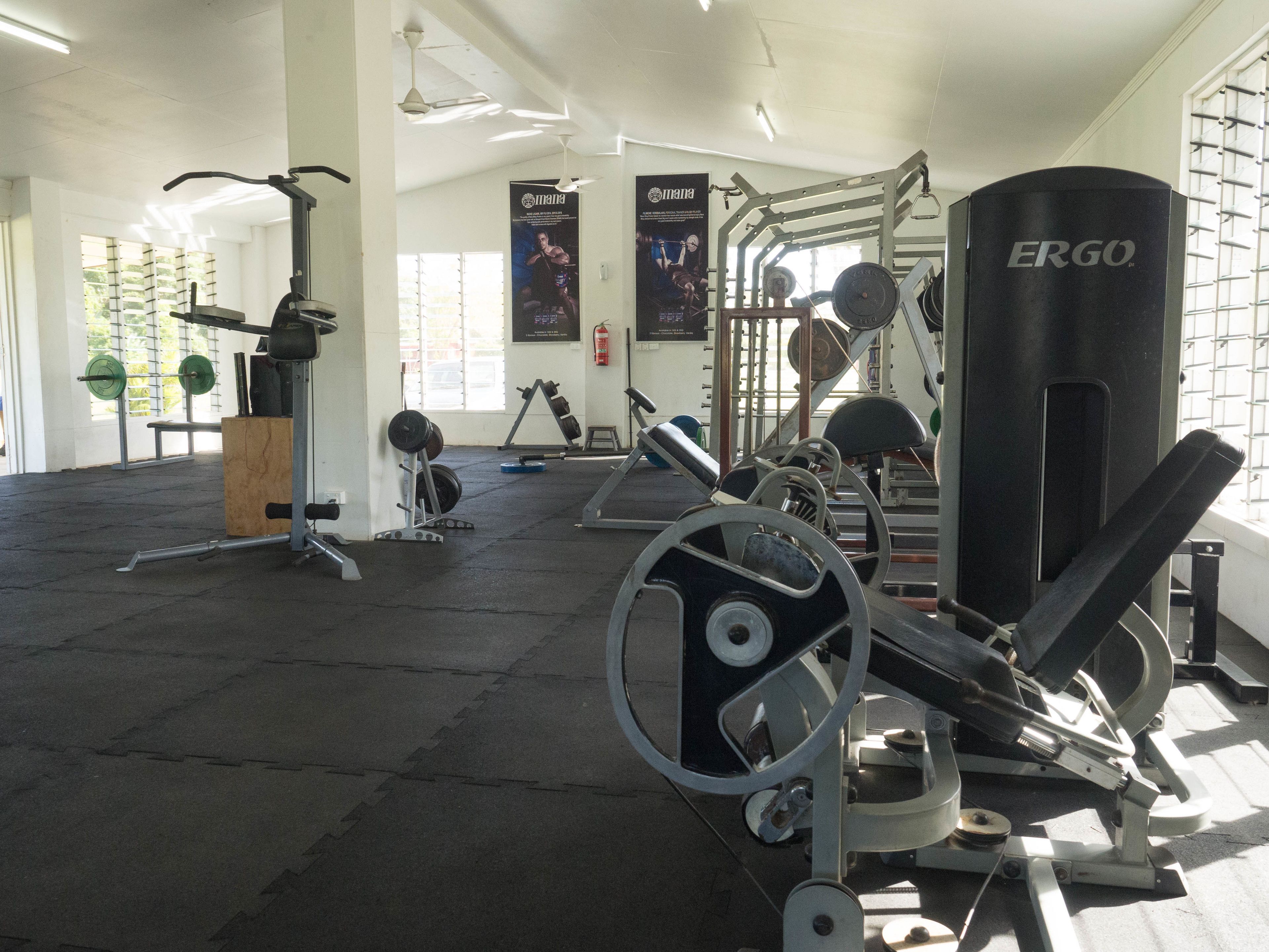 A gym with various exercise equipment, including weight machines and free weights.