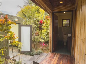A wooden deck leading to a bamboo door, with a bathroom visible inside. - Uprising Beach Resort (Pacific Harbour)
